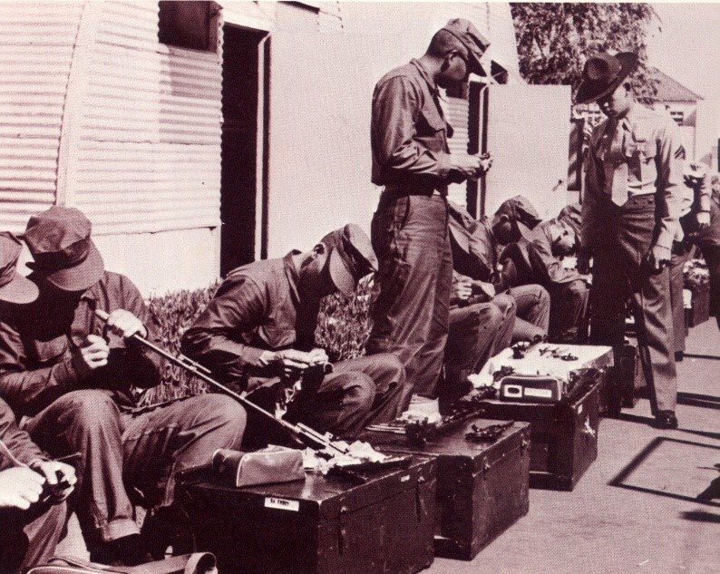 Historical photo of Marines cleaning their weapons
