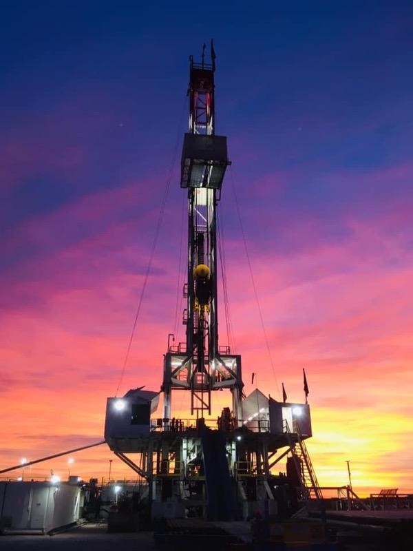 Oil refinery tower at sunset